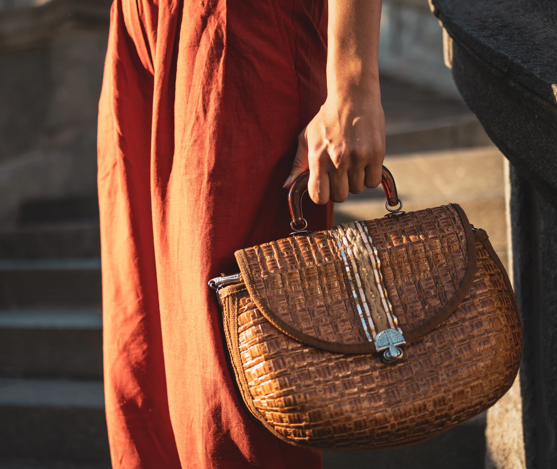 Woman holding a textured brown handbag